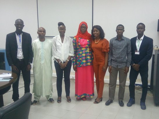 Group of people standing in a row and posing for a picture