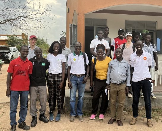 Project team members standing in front of a building