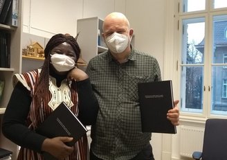 Bernadette Yougbaré with PhD thesis and advisor