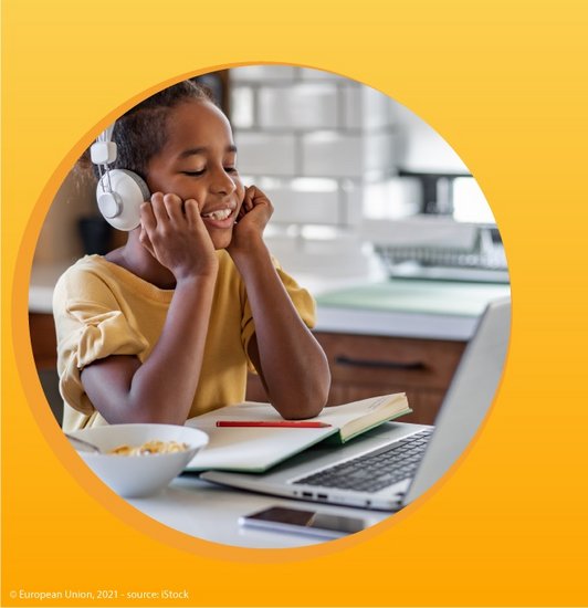 Ein Mädchen mit Kopfhörern am Kopf sitzt vor einem Laptop und stützt seinen Kopf auf die Hände