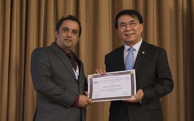 Dr. Basanta Adhikari and a second man holding a certificate