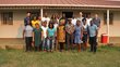 Group of people posing in front of a house for a group picture