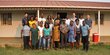 Group of people posing in front of a house for a group picture