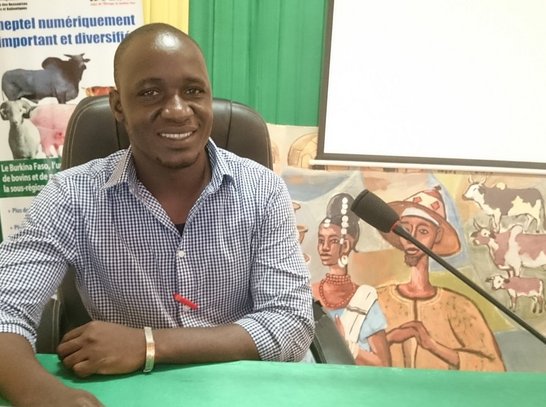 Young scholarship holder from Burkina Faso sitting on a chair in front of the microphone preparing for an interview