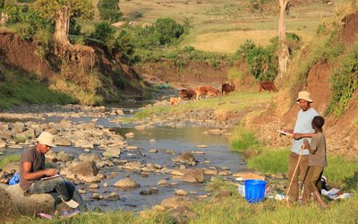  People with clipboards by a river in Ethiopia