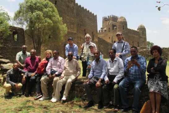 Group of people posing for a picture in front of a castle