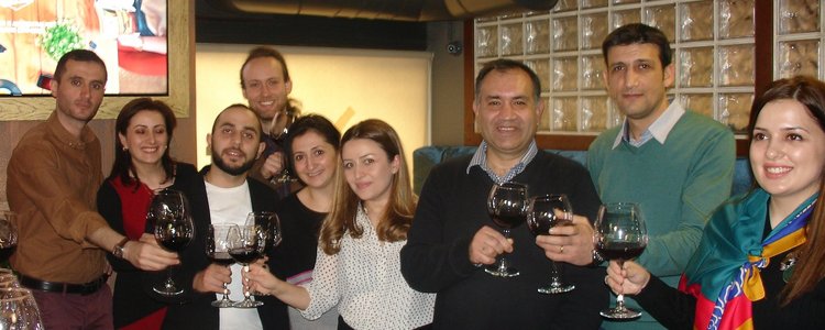 Team members raise their wine glasses to celebrate