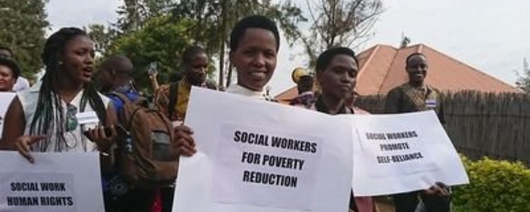 Group of people demonstrating and holding posters with slogans in their hands