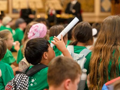 Kind schaut durch Papierrolle