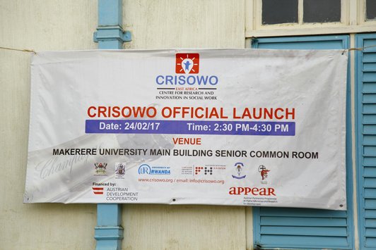 A big white announcement poster with information about the CRISOWO event