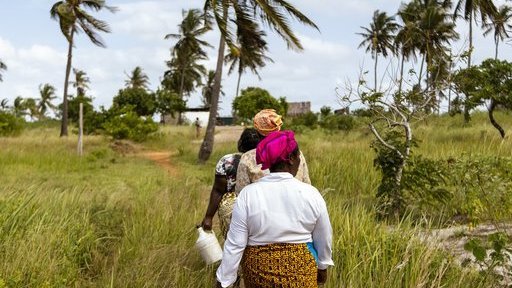 women walking down a path