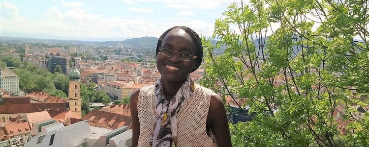 portrait of appear scholar Risper Ondiek with view over city