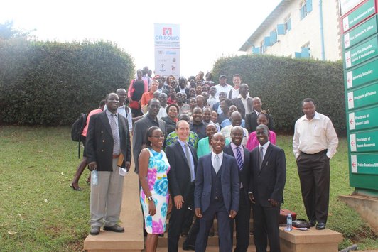 Group of people standing in front of a big CRISOWO poster