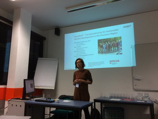 Woman standing in front of a presentation on the wall