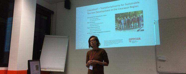 Woman standing in front of a presentation on the wall