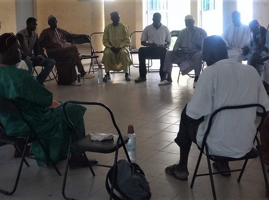 Group of people sitting on chairs arranged in a circle