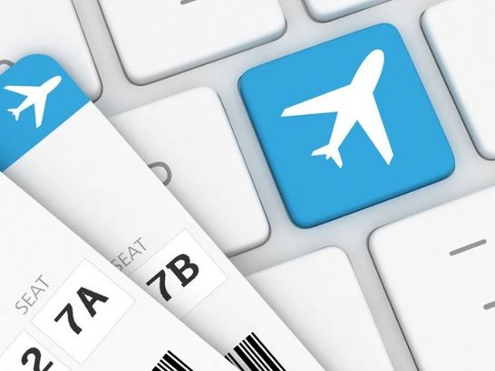 Computer-Tastatur mit einem Flugzeug und Flugtickets drauf
