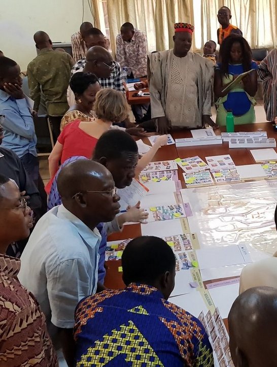 Participants of the workshop sitting around a table and working on the policy simulation