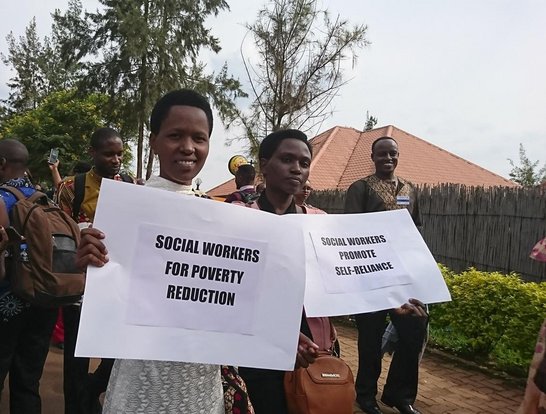 Group of poeople demonstrating and holding white posters and slogans in their hands