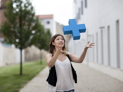 Junge Frau fängt ein blaues Erasmus Logo